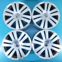 Cztery felgi aluminiowe do Volkswagena Passata B6. Widoczny rozstaw śrub i logo producenta.