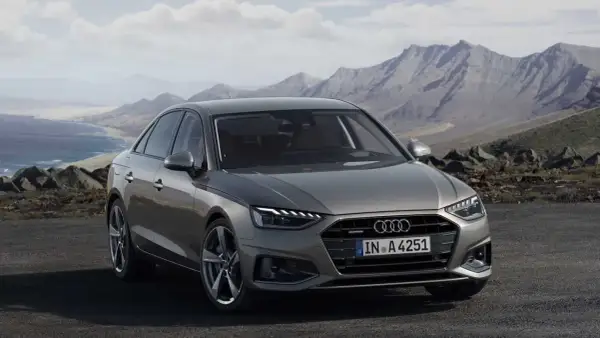 Szary Audi A4 na tle gór i morza. Sprawdź audi a4 wymiary, by zaplanować podróż.