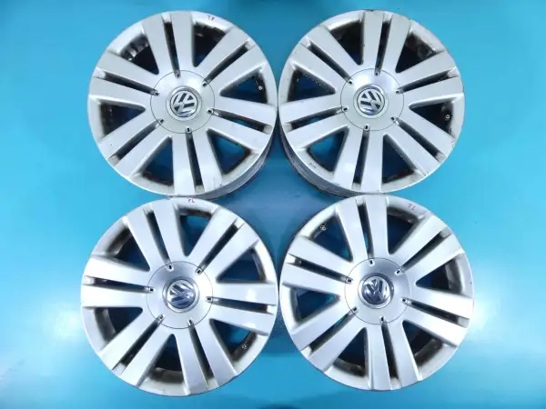 Cztery felgi aluminiowe do Volkswagena Passata B6. Widoczny rozstaw śrub i logo producenta.